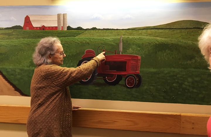 A Memory Care resident reminisces about a tractor they also once had