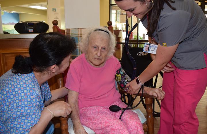 A resident gets her blood pressure checked