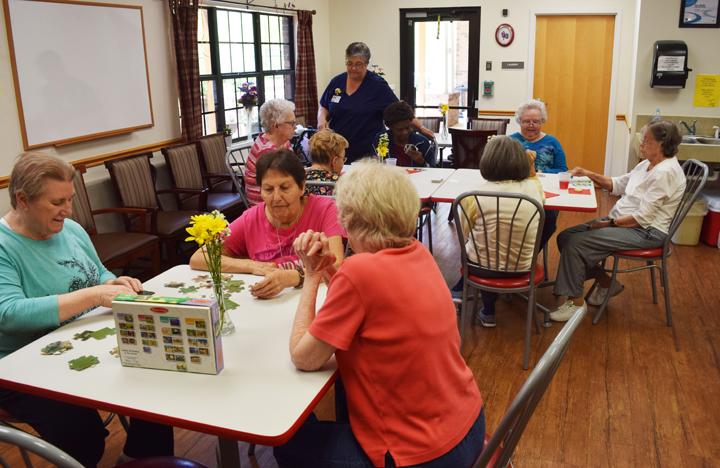 Memory Care residents gather in the activity room for some social time
