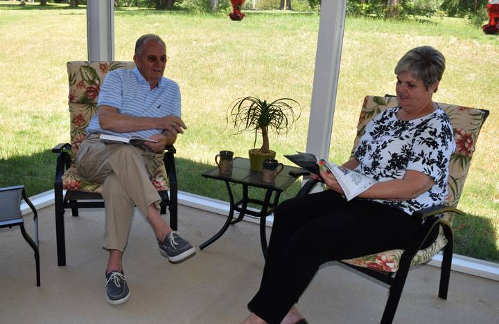 Villa residents enjoy some quiet time on their screened in patio