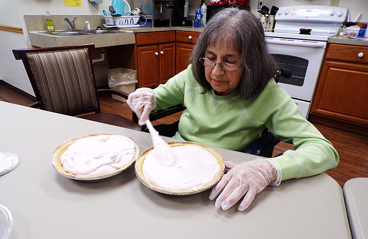 A Memory Care resident making a pie using her own recipe