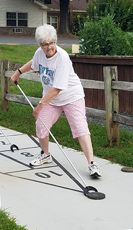 Resident Enjoying a Round of Shuffleboard