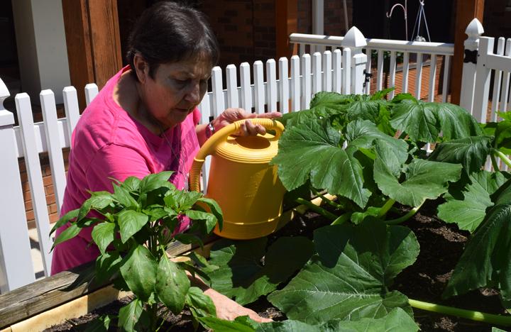 A Memory Care resident enjoys the garden