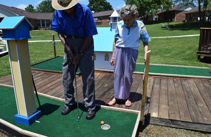 Residents enjoy a round of putt-putt