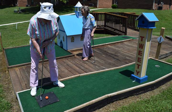 Residents enjoy a round of putt-putt